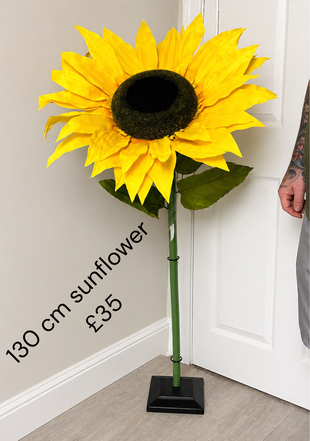 130cm giant yellow artificial sunflower with dark centre and green leaves; display stand not included