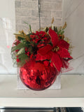 Red and gold Christmas hanging arrangement with red poinsettia-style flowers, greenery, mesh ribbon and a glossy round red bauble