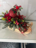 Wooden Christmas sleigh centrepiece with glittery red bauble, red bird, frosted greenery and tartan ribbon
