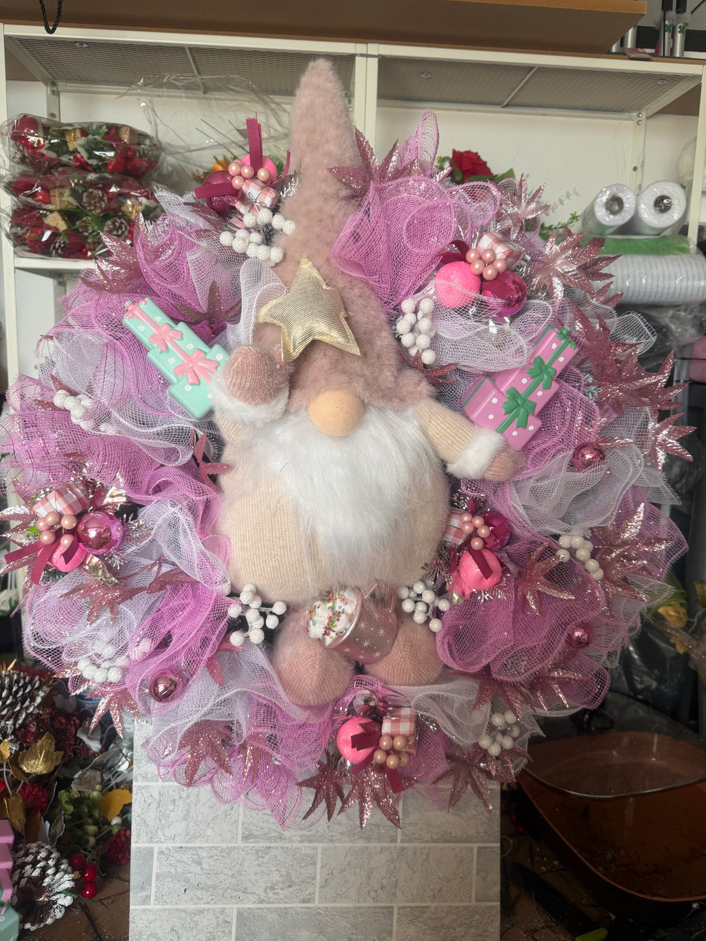 Pink gnome Christmas wreath with sparkling foliage, baubles and white berry accents